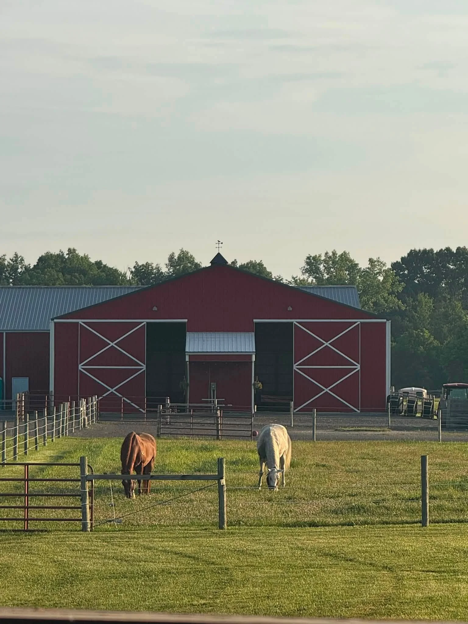 Green paddocks in front of the Legacy Ranch barn